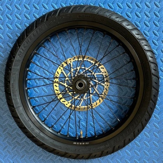 eMoto Michelin Super Moto CST 17X1.6 front wheel and tire set for eMoto bikes, made for Talaria, Surron, ERIDE Pro, and Throne, available at eBike Super Shop, offering exceptional handling and durability for smooth on-road and off-road riding experiences.