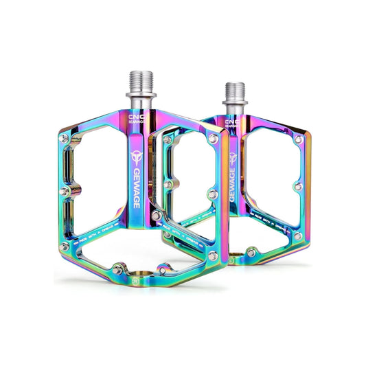 A pair of alloy eBike pedals with a rainbow finish, featuring a textured surface and multiple grip pins for enhanced traction.