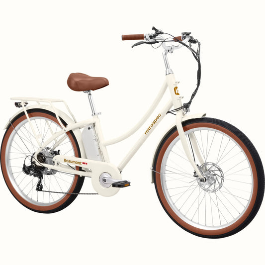Retrospec Beaumont Rev 3 eBike in eggshell color, side view, featuring step-through frame, rear rack, and brown saddle