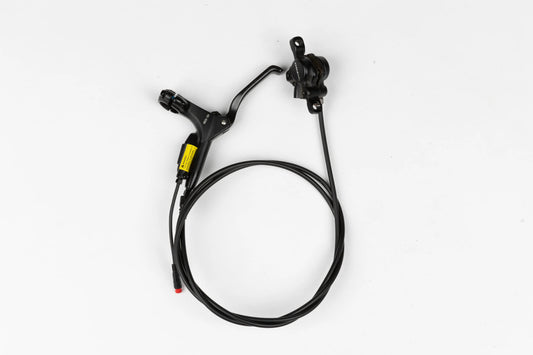 Close-up view of a Super73 front brake assembly, showing the brake caliper, rotor, and mounting hardware attached to the bicycle fork.