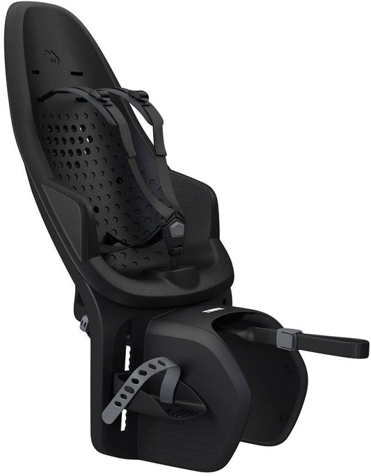 Thule Yepp Maxi 2 child bike seat mounted on a bicycle, featuring a high backrest, adjustable footrests, and a secure harness system.