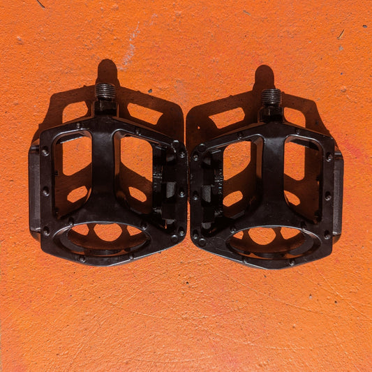 Close-up of a single metal eBike pedal in Style 1, featuring a textured surface and sturdy construction, photographed on a plain white background.