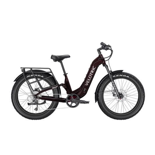 A Velotric Nomad 2X Step-Thru eBike in a side view, showcasing its sturdy frame, wide tires, integrated battery, and step-thru design.