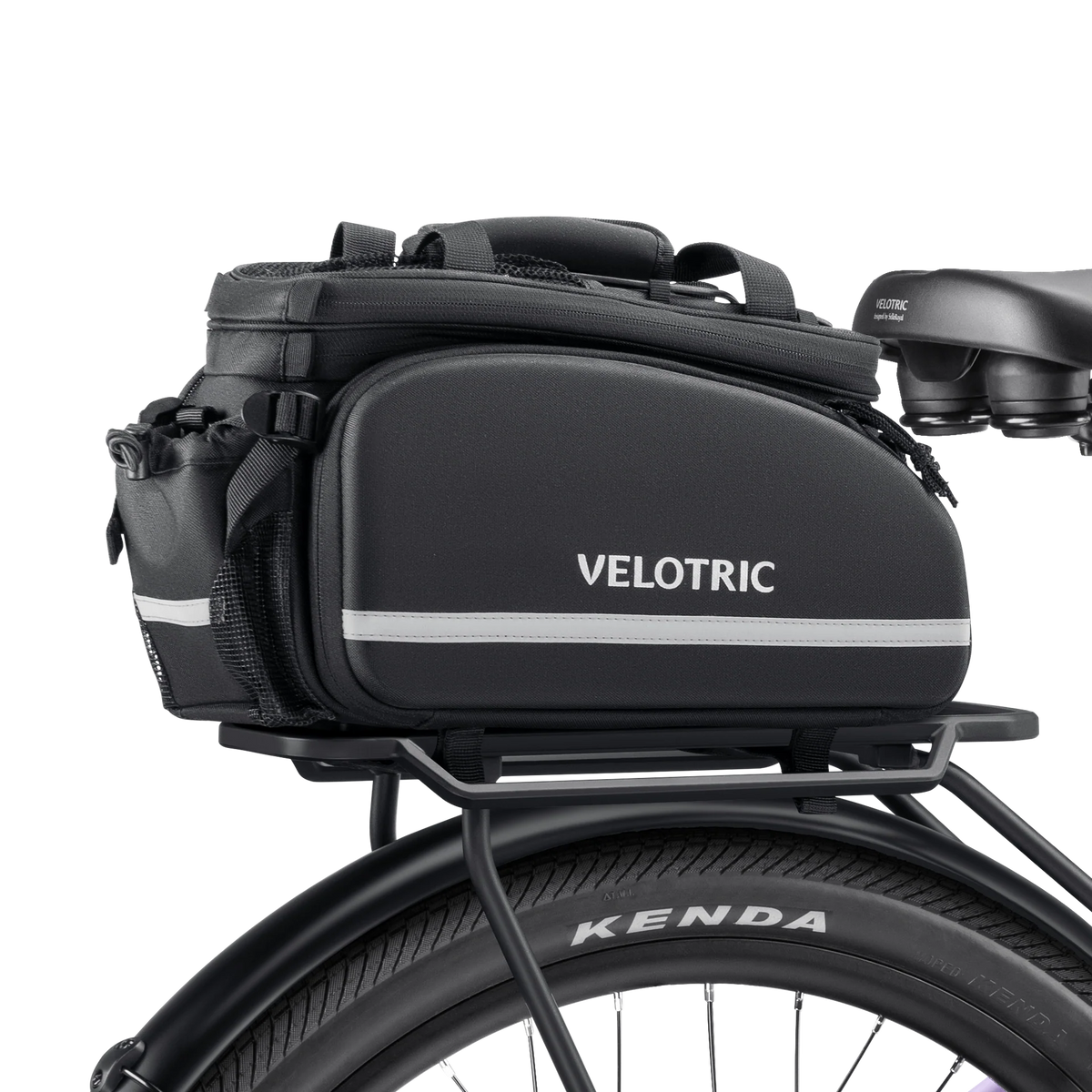 A black Velotric rack top bag with reflective accents, attached to a bicycle rear rack.