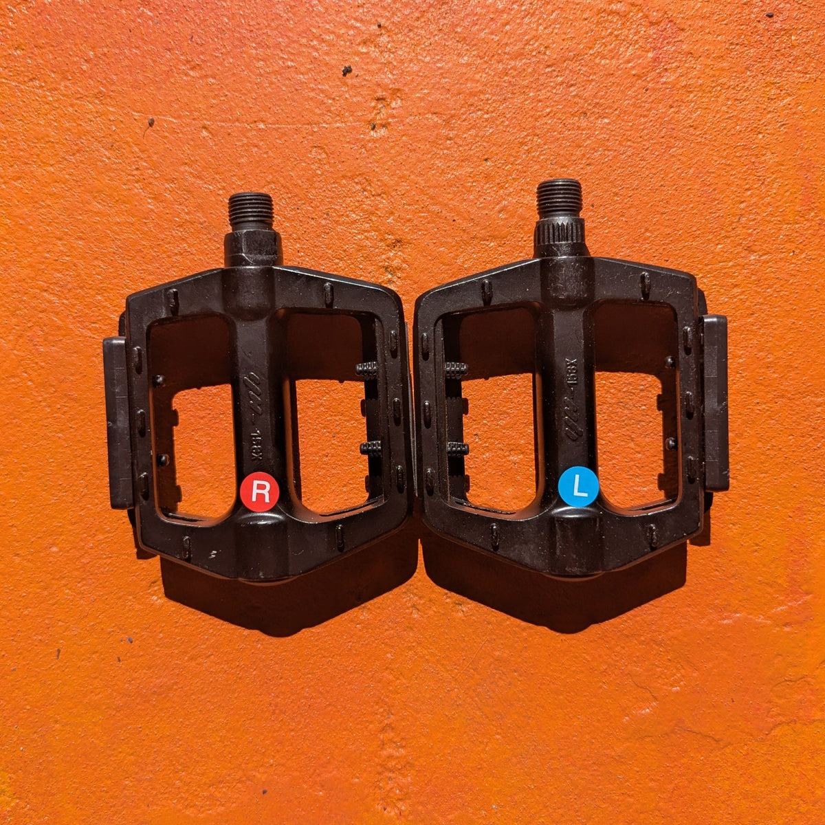 Close-up view of metal eBike pedals in Style 2, featuring a textured surface and sturdy construction, designed for enhanced grip and durability.