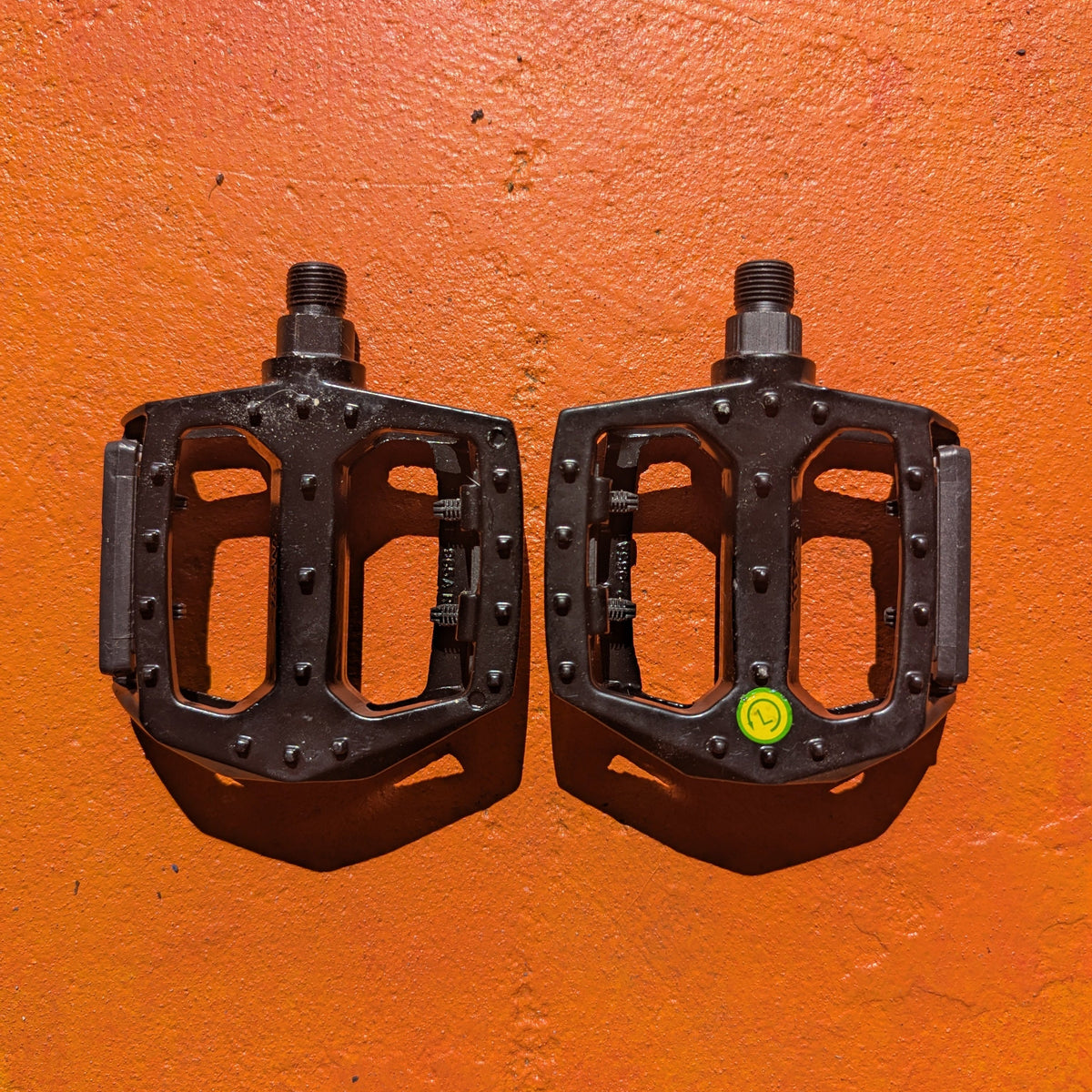 Close-up view of a pair of metal eBike pedals in Style 3, featuring a textured surface and sturdy construction, displayed on a white background.