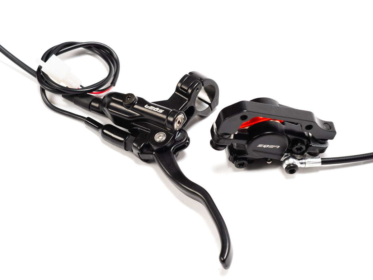 Stomp Ebox rear brake complete system showing brake caliper, disc, master cylinder, and connecting brake line on a white background.