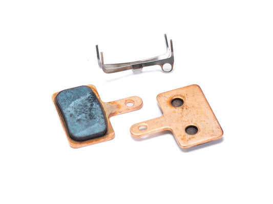 Stomp Ebox sintered brake pads in packaging, showing front view with branding and product details visible.