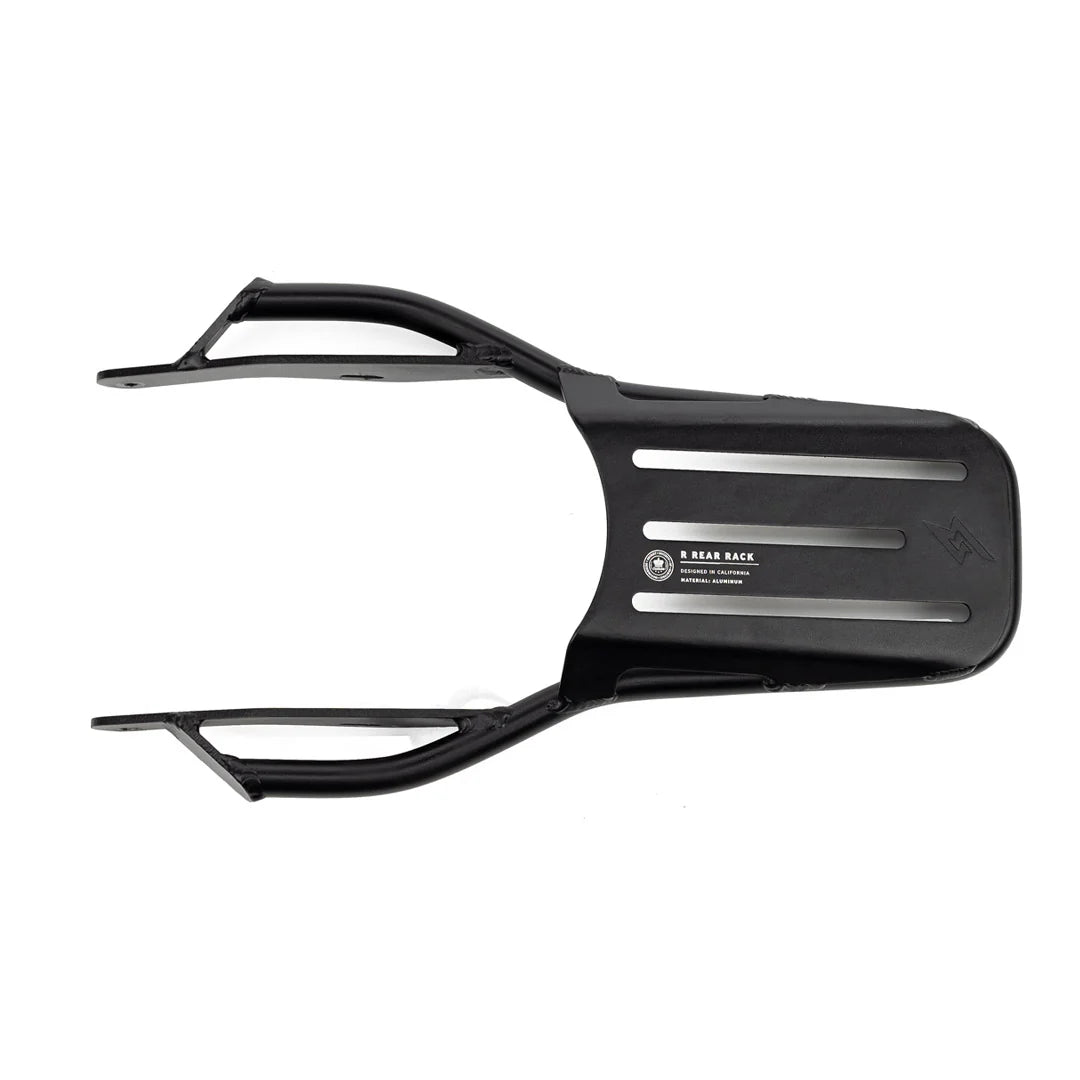 Rear rack for SUPER73 electric bike, black metal frame, mounted above rear wheel, designed for carrying cargo or accessories.